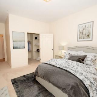 A modern bedroom with stylish decor and cozy bedding.