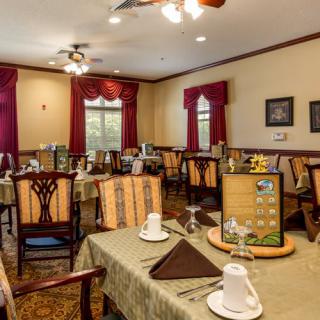A cozy dining room with elegantly set tables, ready for guests.