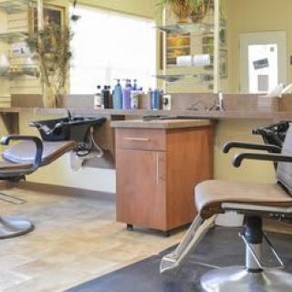 A cozy hair salon interior with modern chairs and styling stations.