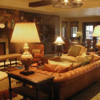 A cozy living room with warm lighting, featuring comfortable sofas and elegant lamps.