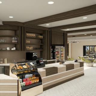 A modern caf� interior featuring a sleek counter, display shelves, and seating area.