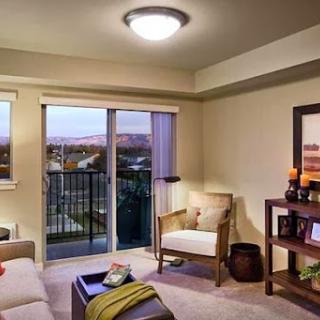 A stylish living room featuring modern furniture and a beautiful balcony view.
