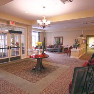 A cozy lobby with a central table, comfortable seating, and elegant decor.