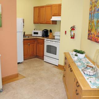 A cozy kitchen featuring wooden cabinets and modern appliances.