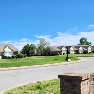 A serene view of a residential neighborhood under a clear blue sky.