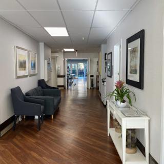 A well-lit hallway featuring contemporary decor and comfortable seating.