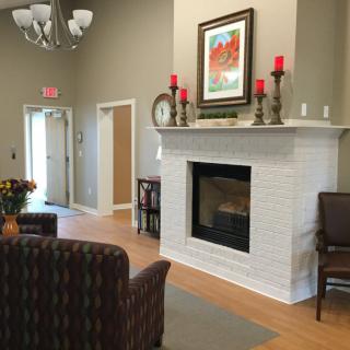 Cozy living room interior with a fireplace and comfy seating.