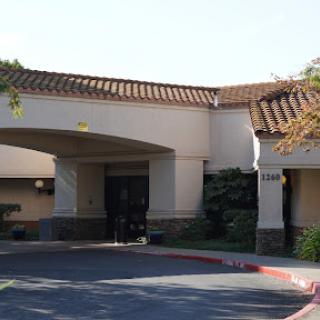 A welcoming hotel entrance with a landscaped area.