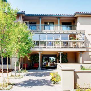A modern building with a welcoming entrance and surrounding greenery.