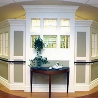 A well-decorated hallway with a small table and plant.