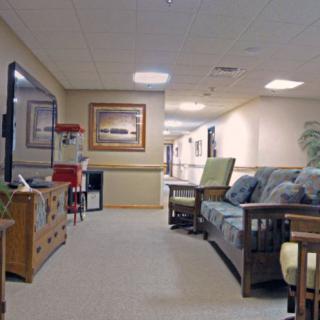 A cozy seating area in a hallway, featuring couches and decorative elements.