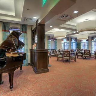 A well-furnished lobby with a grand piano and a comfortable seating area.