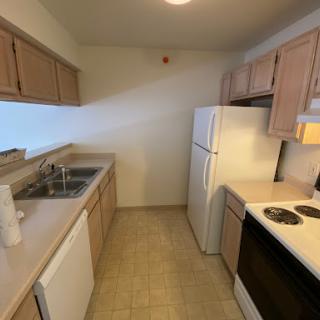 A compact and functional kitchen featuring essential appliances and cabinetry.