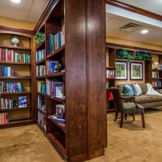 A cozy library interior with wooden bookshelves and a comfortable reading area.