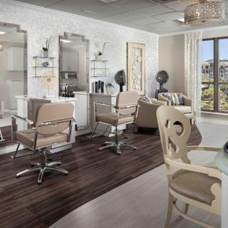 A modern and stylish salon interior with hair styling chairs, large mirrors, and ample natural light.