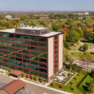 Aerial view of an office building surrounded by greenery.