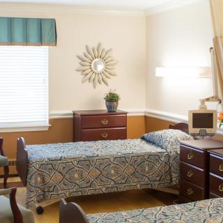 A cozy bedroom with twin beds and classic decor.