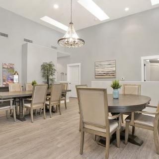 A modern dining room featuring elegant furniture and stylish lighting.