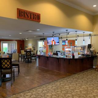An inviting bistro interior with a counter and seating area.