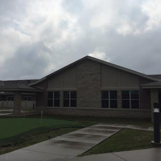 A modern residential building under a cloudy sky.