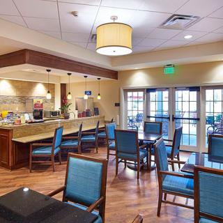 A contemporary dining area with stylish seating and warm lighting.