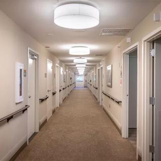 A well-lit interior hallway with multiple doors and modern fixtures.