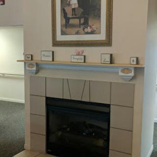 A cozy living room setup featuring a stylish fireplace and decorative mantel.
