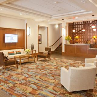 A modern hotel lobby with comfortable seating and a welcoming reception area.