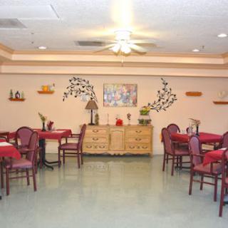 A cozy restaurant interior featuring red tablecloths and wooden furniture.