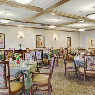 An elegantly decorated dining room with set tables and comfortable seating.