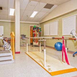 A well-equipped physical therapy room featuring various exercise tools and rehabilitation aids.