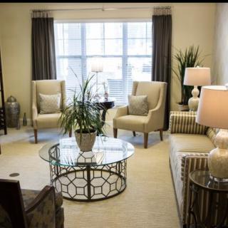 A well-decorated living room featuring comfortable seating, a stylish coffee table, and soft lighting.