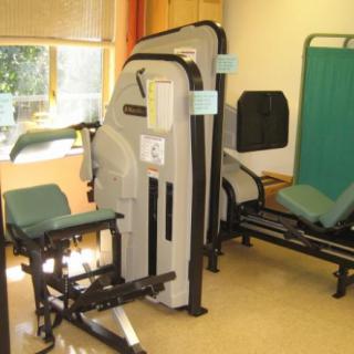 A room with various exercise machines for fitness training.