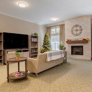 A modern living room featuring a cozy fireplace, large television, and elegant sofa with stylish decor.