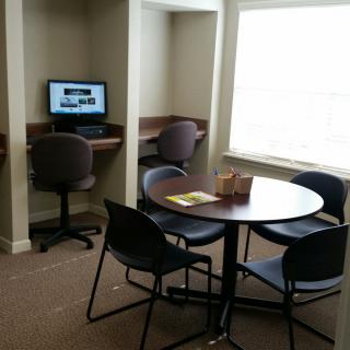 A cozy study area with computer stations and a round table for group work.