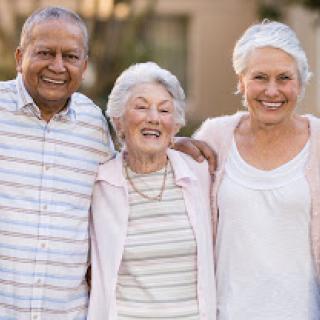 Three elderly friends enjoying a joyful moment together.