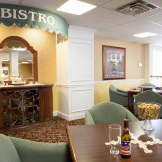 A cozy bistro dining area with tables and chairs arranged neatly, and a welcoming atmosphere.