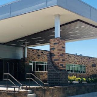 A modern building entrance featuring a combination of brick and contemporary design elements.