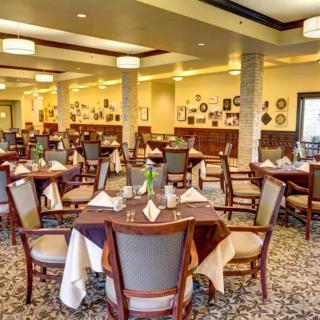 An elegant dining room with neatly arranged tables and chairs, creating a cozy ambiance.