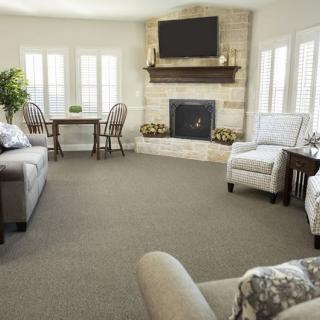 Spacious living room with comfortable seating, a fireplace, and a TV above the mantel.