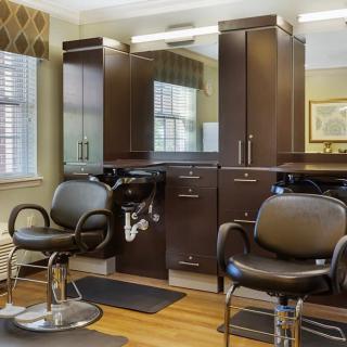 A modern hair salon with stylish chairs and mirrors.