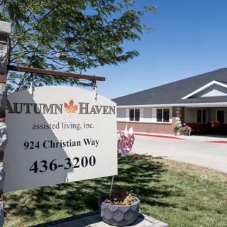 Sign for Autumn Haven senior living facility with building in the background.