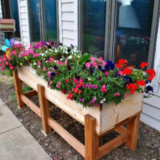 A vibrant flower box filled with a variety of blooming plants enhances the outdoor space.