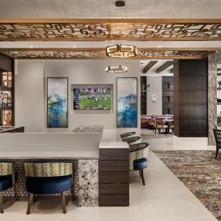 A modern and elegantly designed living space featuring a dining area, stylish furniture, and artistic decor.