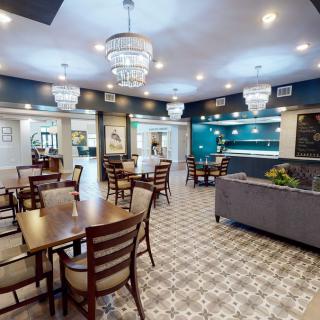 A modern dining area with elegant chandeliers and stylish furnishings.