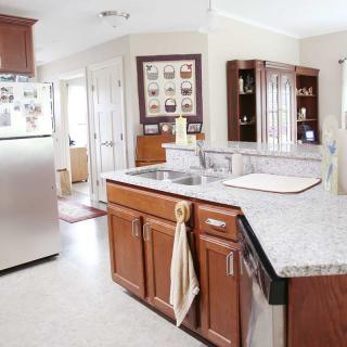 A modern kitchen with wooden cabinets and a central island.