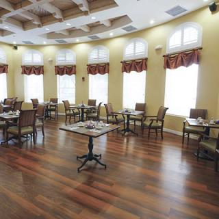 A spacious dining room with elegant furnishings and large windows.
