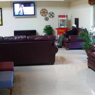 A quiet lobby area with comfortable seating, a television, and a popcorn machine.