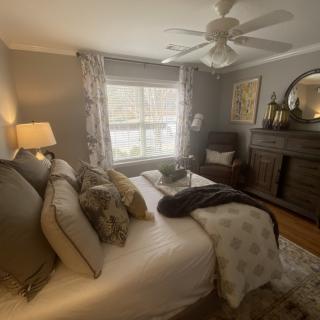 Cozy bedroom with elegant decor and natural lighting.