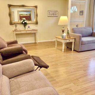 A cozy living room with comfortable sofas, a large mirror, and elegant decor.